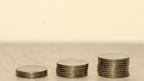Three stacks of coins, each taller than the last