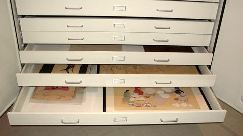 Wide flat-file drawers pulled open in an archive