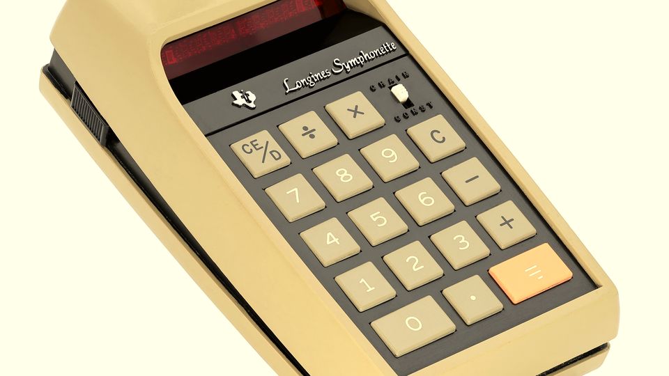A vintage desktop calculator with a red display