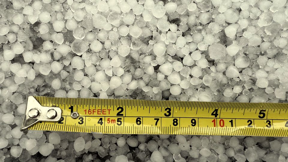 A tape measure stretched across small white pellets