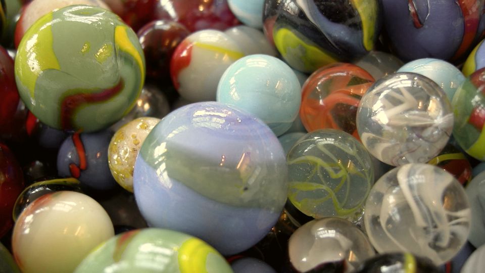 A heap of many differently coloured glass marbles